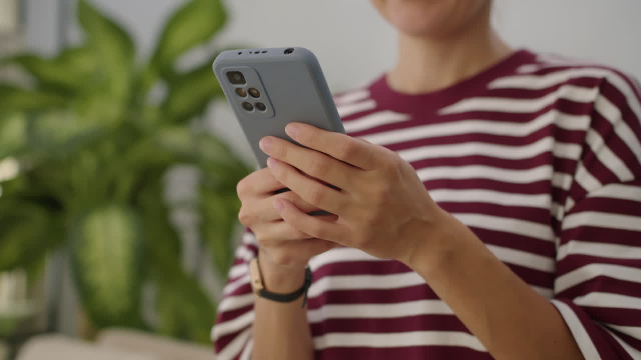 Female Manager Using Smartphone when Homeworking