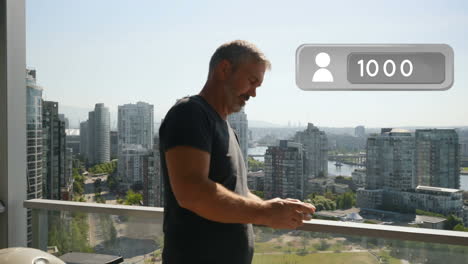 man texting on his phone while leaning on veranda rails