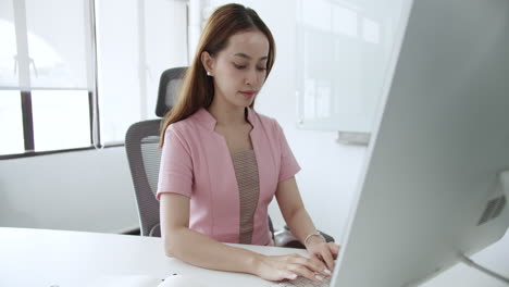 a young professional diligently works at her desk embodying productivity and focus.