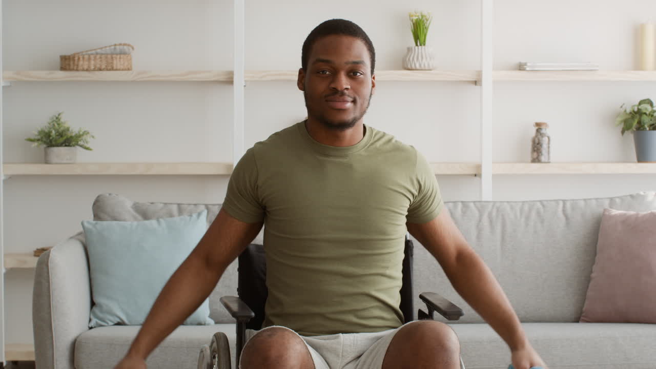 Man in Wheelchair Exercising with Dumbbells