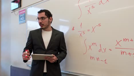 university professor teaching calculus with a tablet