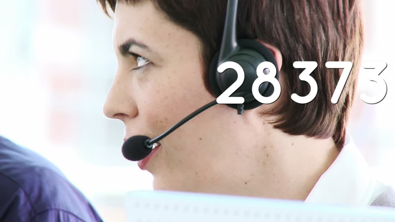 Animation of numbers over caucasian businesswoman using phone headset