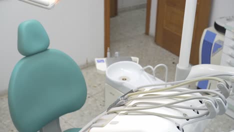 top view of an empty blue dentist's chair in an unoccupied dental clinic with the turbines set up to improve the dental health of patients