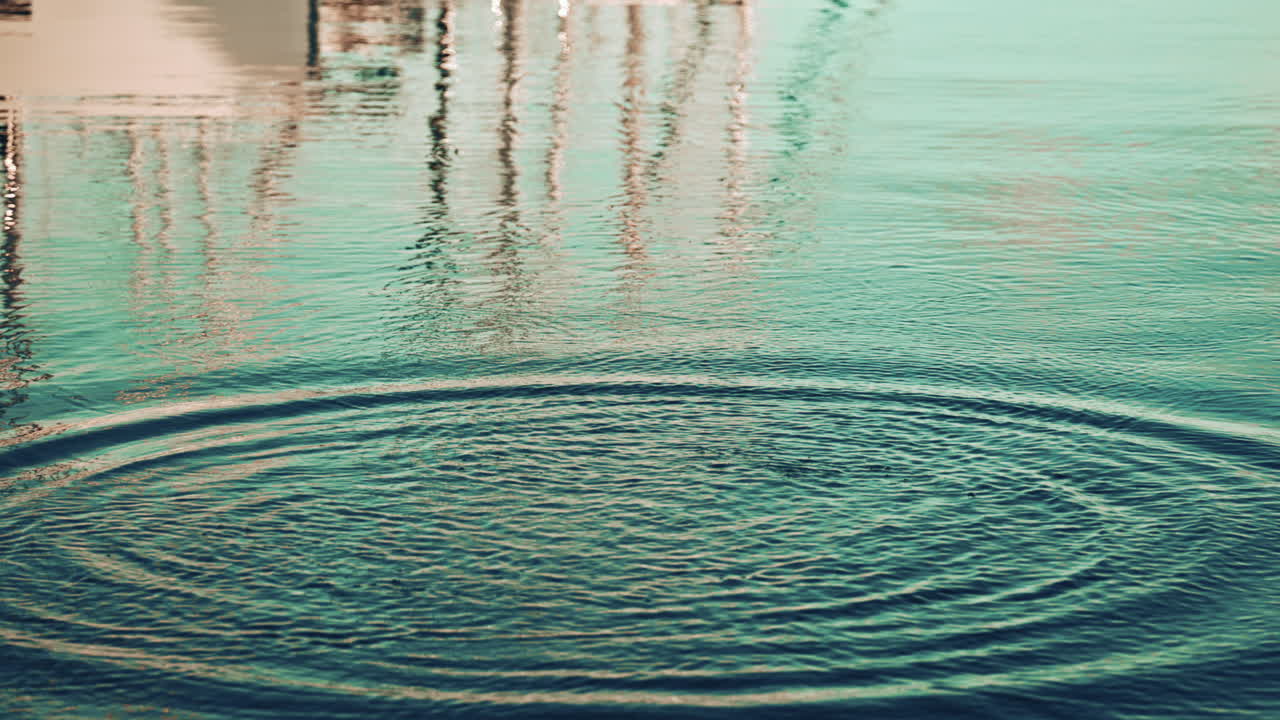 A fish jumping out of the water, creating splashes and ripples, with reflections of boats and masts on the surface