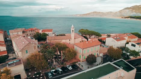 drone volando a través de la ciudad costera, algajola, córcega