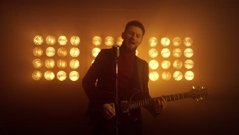 Man-singer-performing-song-in-nightclub.-Handsome-musician-singing-microphone.