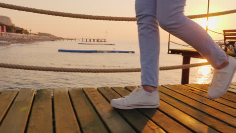 morning jog on the pier when the sun rises over the sea in the frame only the legs are visible stead