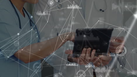 animation of data and connections over hands of diverse female and male doctors using tablet