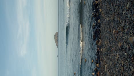 Vertical-shot-of-La-Vacca-Island-islet-seen-from-Sant'Antioco-sea-coast