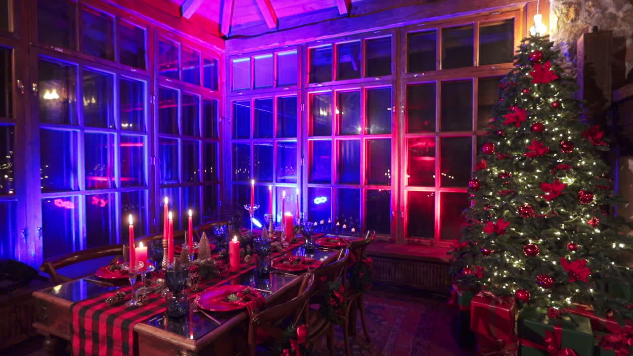 Wonderful festive room with red and blue lights. Old manor hall with beautifully laid table and Christmas tree.