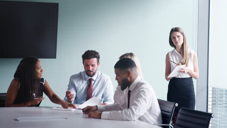 Group-Collaborating-On-Task-At-Graduate-Recruitment-Assessment-Day-Whilst-Being-Observed-By-Recruitment-Team