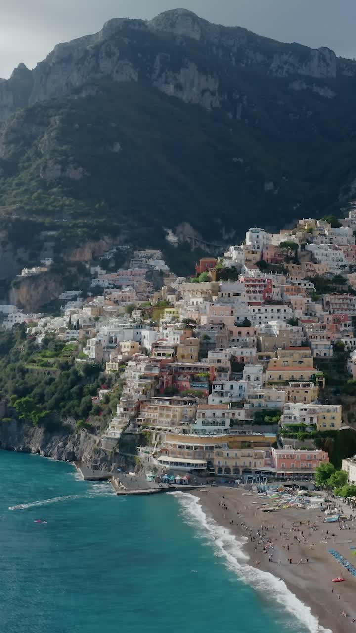 Italy's Most Iconic and Picturesque Amalfi Coast Beachfront Village Positano.Vertical Aerial View of Positano with Pastel-colored Houses along the Cliffside and Turquoise Mediterranean Sea Water