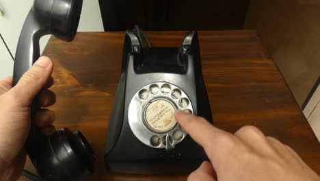 4k clip of an classic old black rotary dial phone