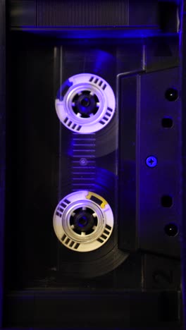 vertical 4k, vintage audio cassette tape spinning during playback or recording