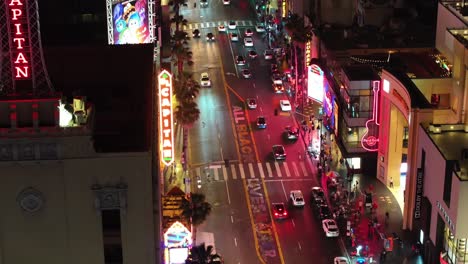 neon signs and nighttime traffic on hollywood boulevard, california with all black lives matter painted on the street