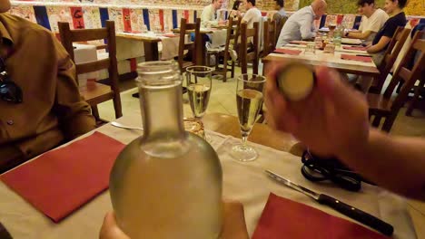 person pouring water into a glass