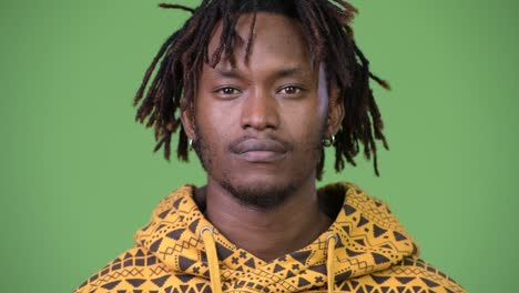 young handsome african man covering eyes as three wise monkeys concept