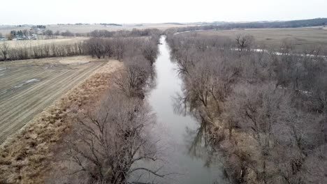 winter time aerial drone video of the skunk river and the rich agricultural farmland surrounding rural lynnville, iowa