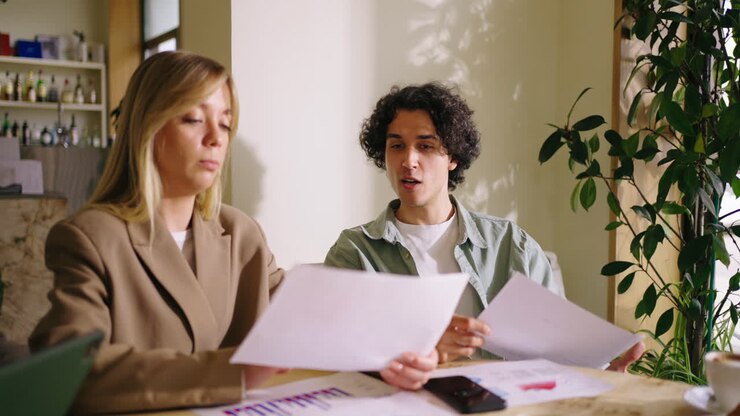 Two people discussing business over a cup of coffee