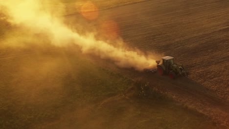 Tractor-With-Implements-Working-In-Agricultural-Fields-On-A-Sunny-Summer-Evening