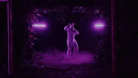 man in white suit with mask in purple light tunnel