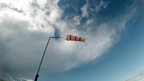 Orange-beach-safety-windsock-indicator-measuring-weather-direction