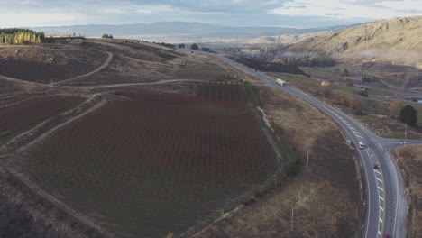 aerial drone shot cresting a hill to reveal the town of alexandra in south island, new zealand