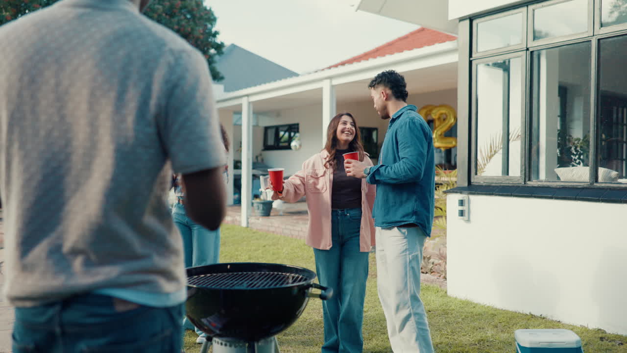 Friends celebrating at a backyard party with a barbecue grill