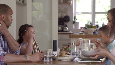 Family-At-Home-Eating-Meal-In-Dining-Room-Together