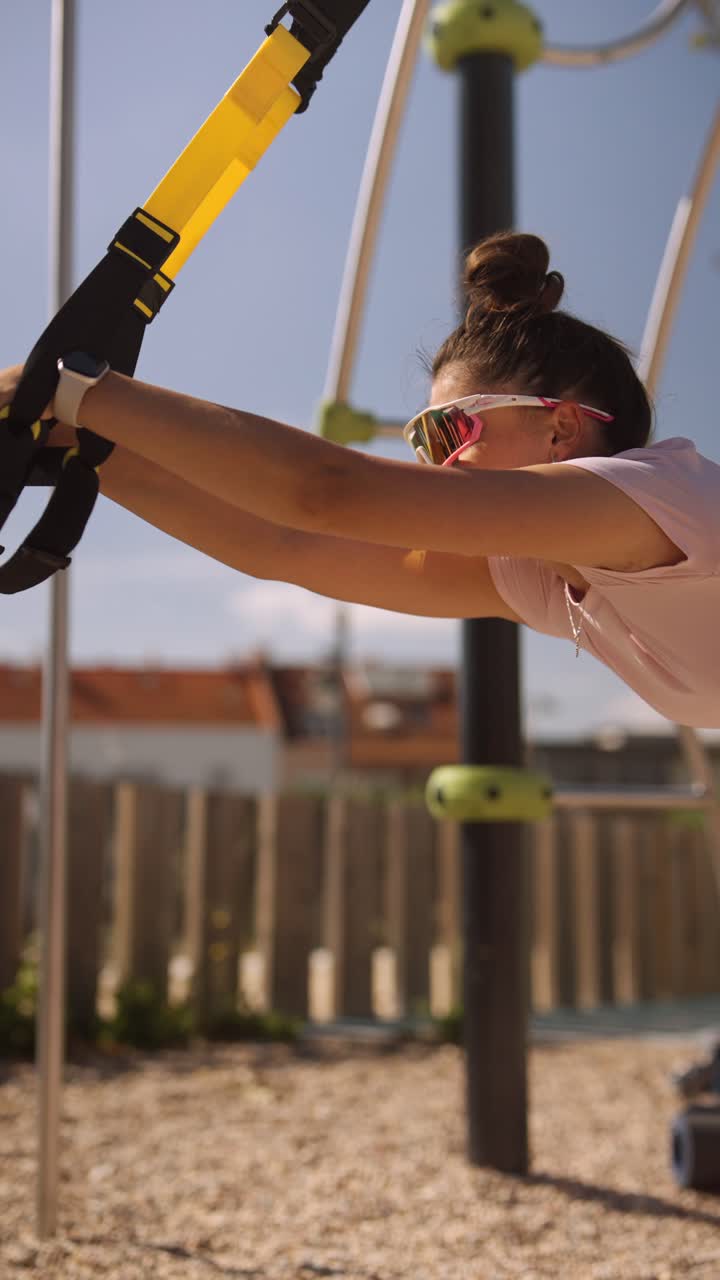Woman Exercising with Resistance Bands in a Park