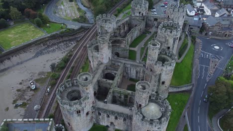 Conwy-Castillo-Medieval-Mercado-Amurallado-Ciudad-Histórica-Vista-Aérea-Tire-Hacia-Atrás