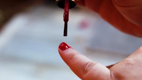 young girl doing nail polish on nails at day in details