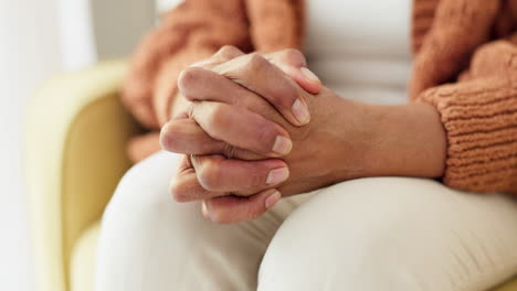 hands, stress and senior woman on a sofa