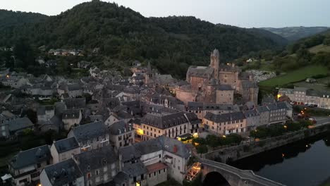 aerial view of a medieval castle and village at dusk