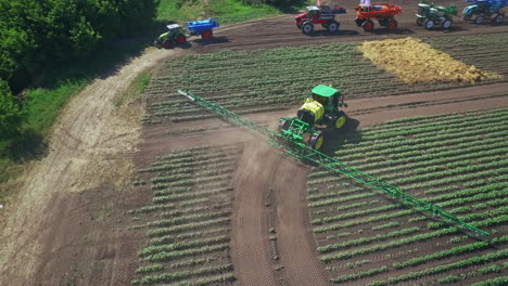 agricultural sprayer watering plant on farming field. farming machinery