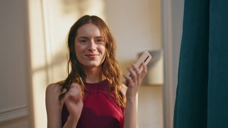 joyful girl talking cell looking mirror closeup. happy woman reflection admire