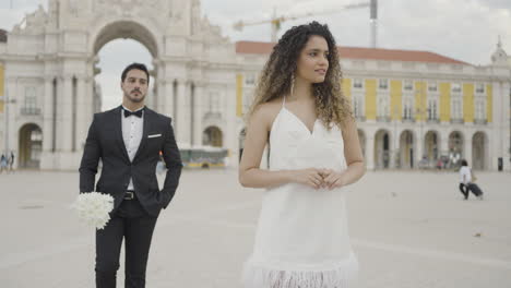 couple walking in a city square