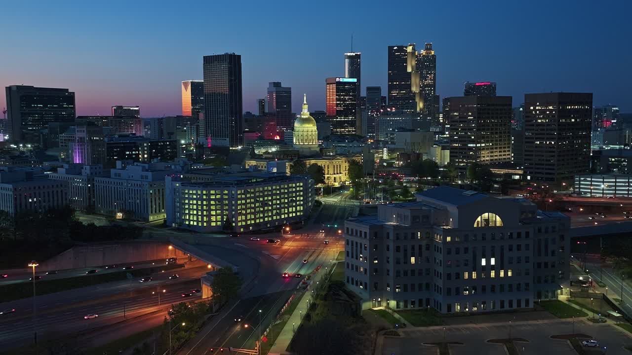 Atlanta Skyline lighting in warm lights at twilight.Aerial Panorama wide shot. Traffic scene on underpass highway and skyscrapers buildings. Sunset time in american city in Georgia, USA.