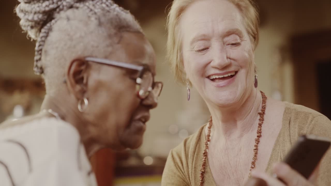 Elderly Women Sharing and Enjoying Content on a Smartphone