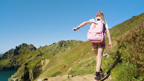 girl hiking on a mountain path