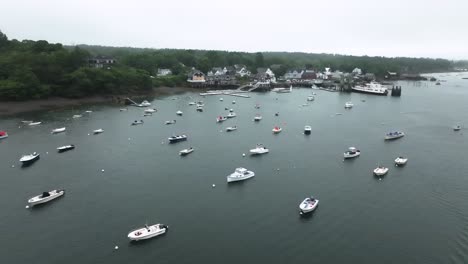 aerial view of north haven, maine, showcasing a charming coastal village, boat-filled harbor, and surrounding forested islands on a calm summer day.