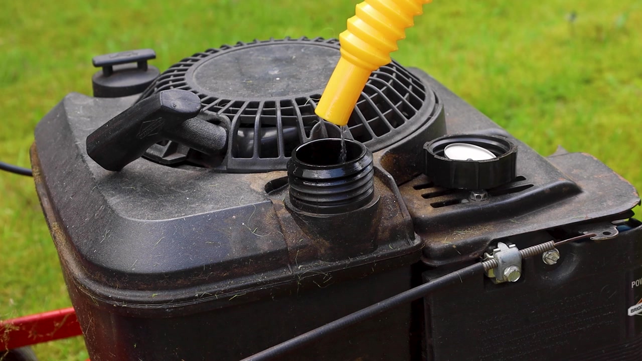 Video filling the fuel tank of a mower.