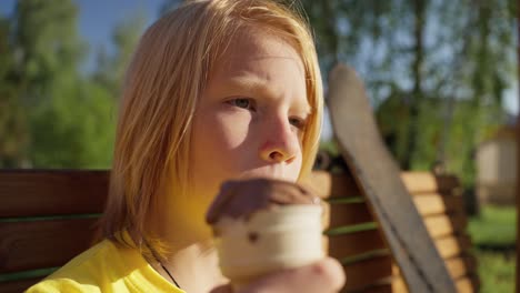 child eating ice cream outdoors