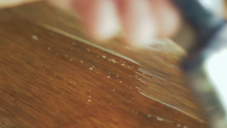 brushing varnish over plywood close up