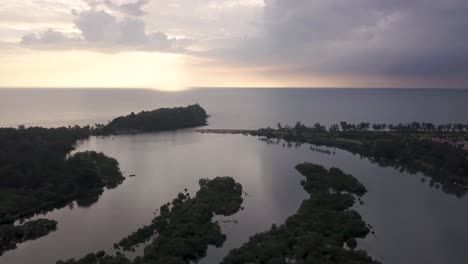 Sunset-over-the-waves-and-tropical-landscape-of-South-Goa,-India--aerial