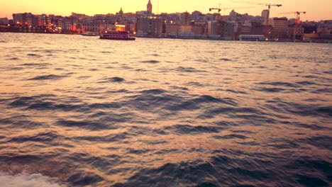 Slow-motion:-Landscape-view-of-Galate-Tower-and-Bosphorus-at-sunset-while-cruising-in-Istanbul,Turkey