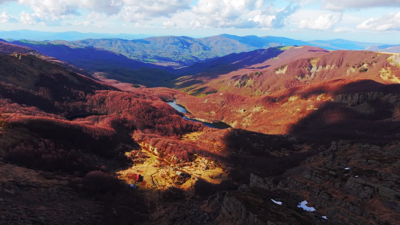 Golden hour view over autumn valleys and lakes in the Dolomites mountains