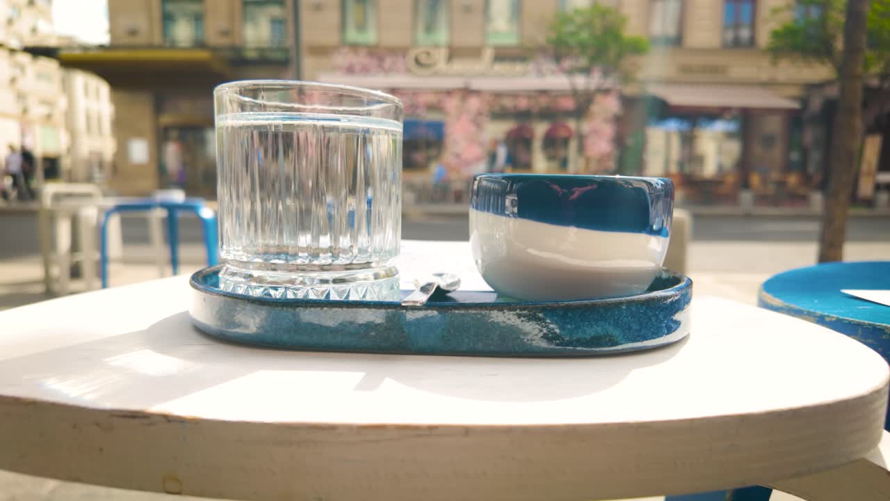 Slowmotion video of coffee served on sidewalk table
