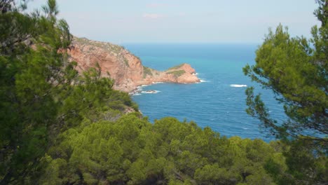 Steady-view-of-beautiful-colorful-coastline-with-cliffs,-mountains-and-crystal-blue-water-in-Costa-Brava,-Spain