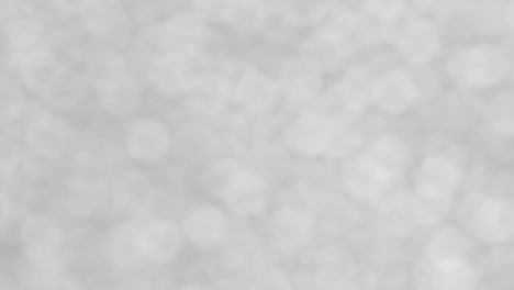 white sparkling abstract background with bokeh from white circles.